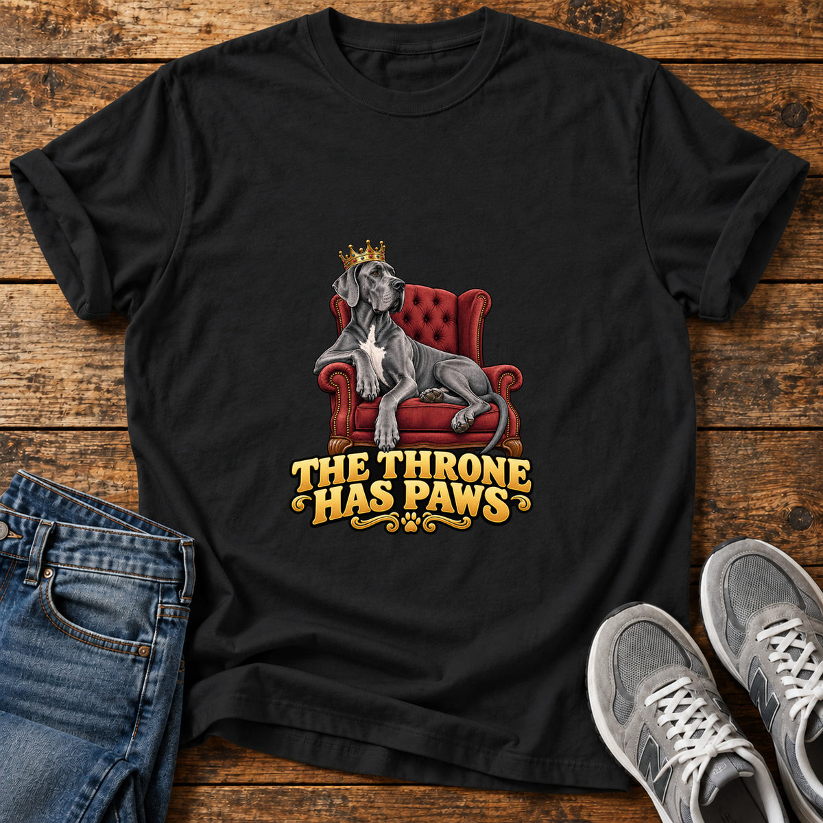 Throne Paws Majesty Great Dane graphic T-shirt in Black, shown on a flat-lay shirt mockup