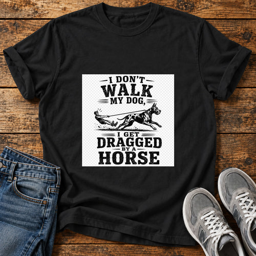 Dragged By Horse Great Dane graphic T-shirt in Black, shown on a flat-lay shirt mockup