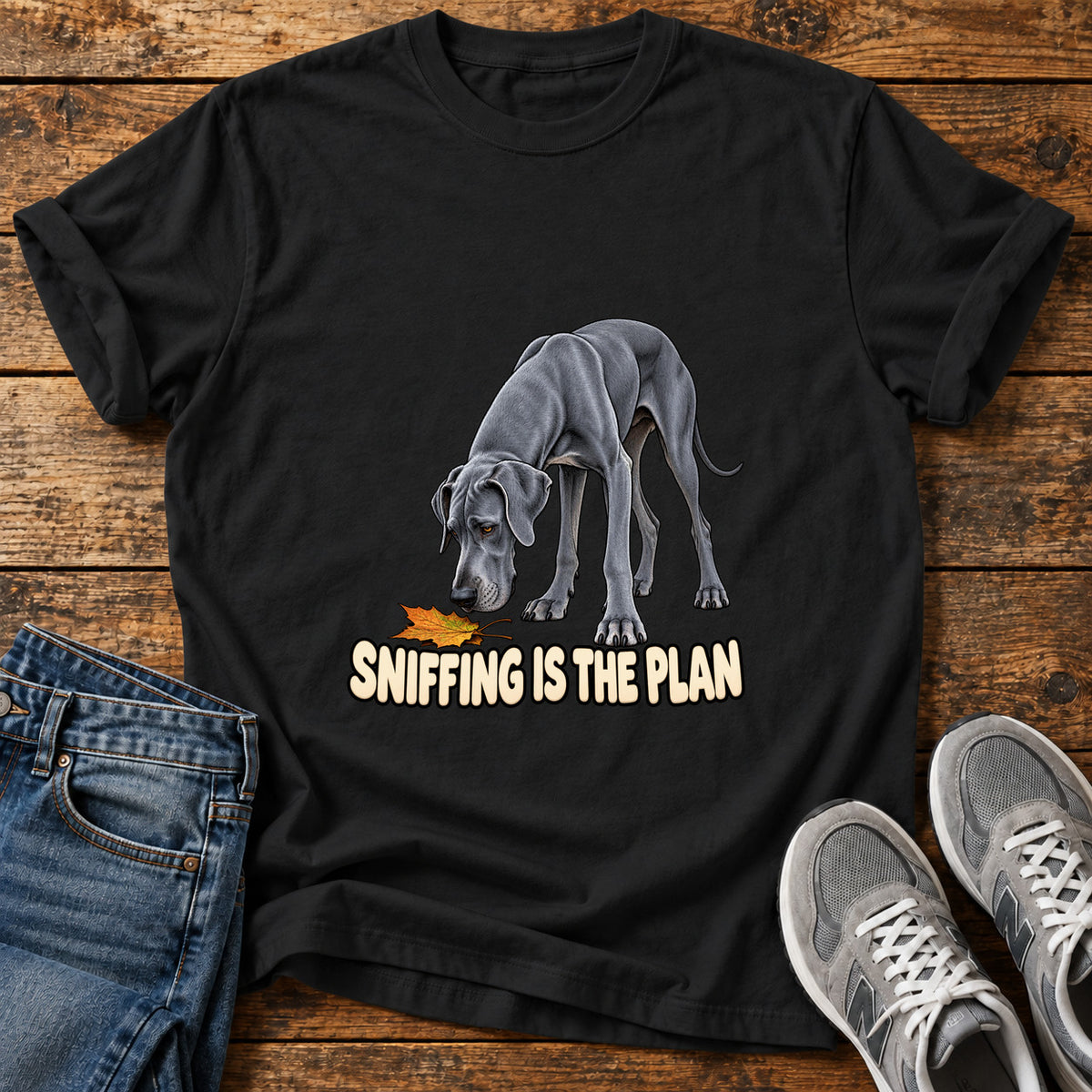 Sniffing Plan Great Dane graphic T-shirt in Black, shown on a flat-lay shirt mockup