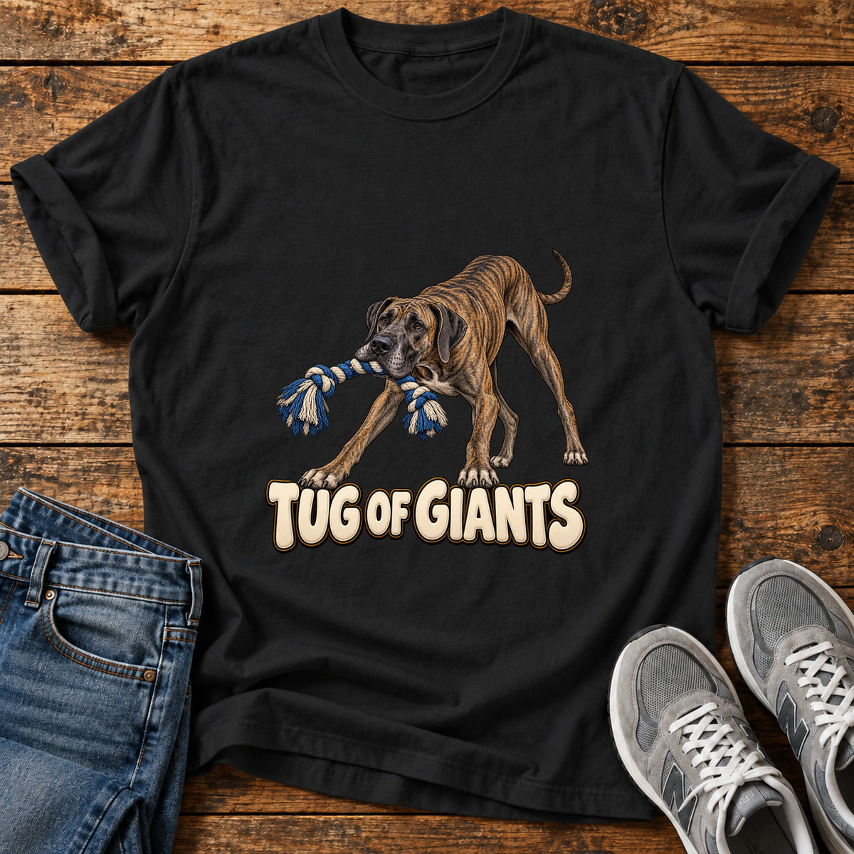 Tug of Giants Great Dane graphic T-shirt in Black, shown on a flat-lay shirt mockup