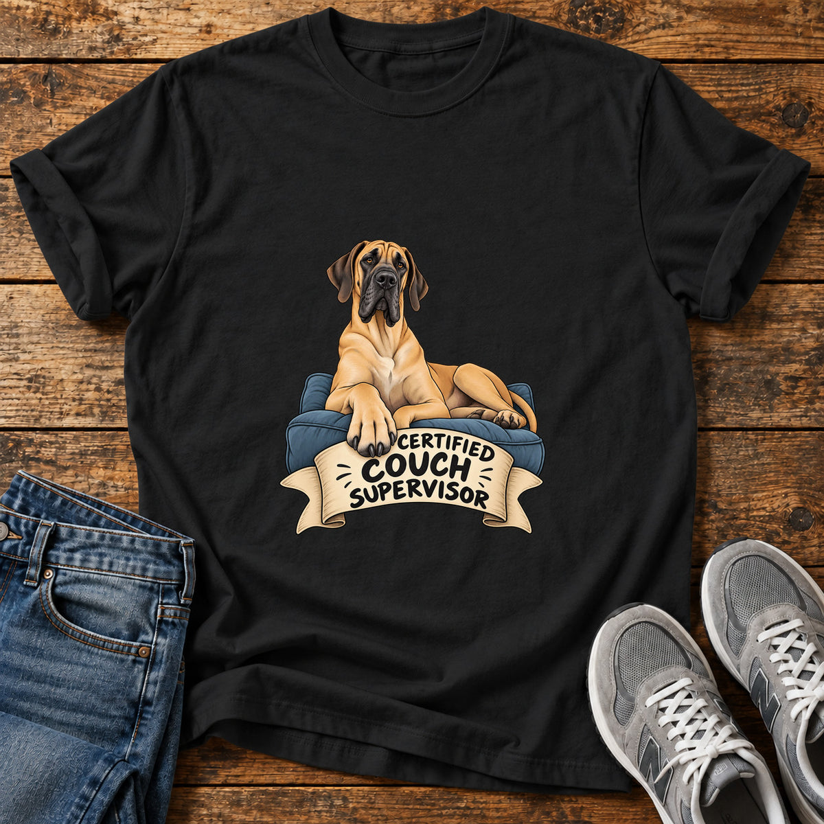 Certified Couch Supervisor Great Dane graphic T-shirt in Black, shown on a flat-lay shirt mockup
