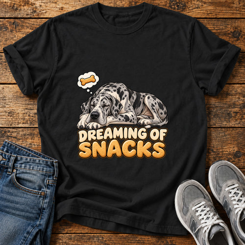 Dreaming Snacks Great Dane graphic T-shirt in Black, shown on a flat-lay shirt mockup