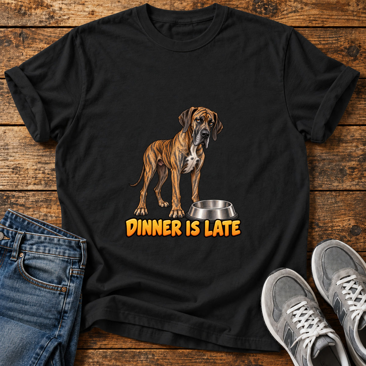 Dinner Is Late Great Dane graphic T-shirt in Black, shown on a flat-lay shirt mockup