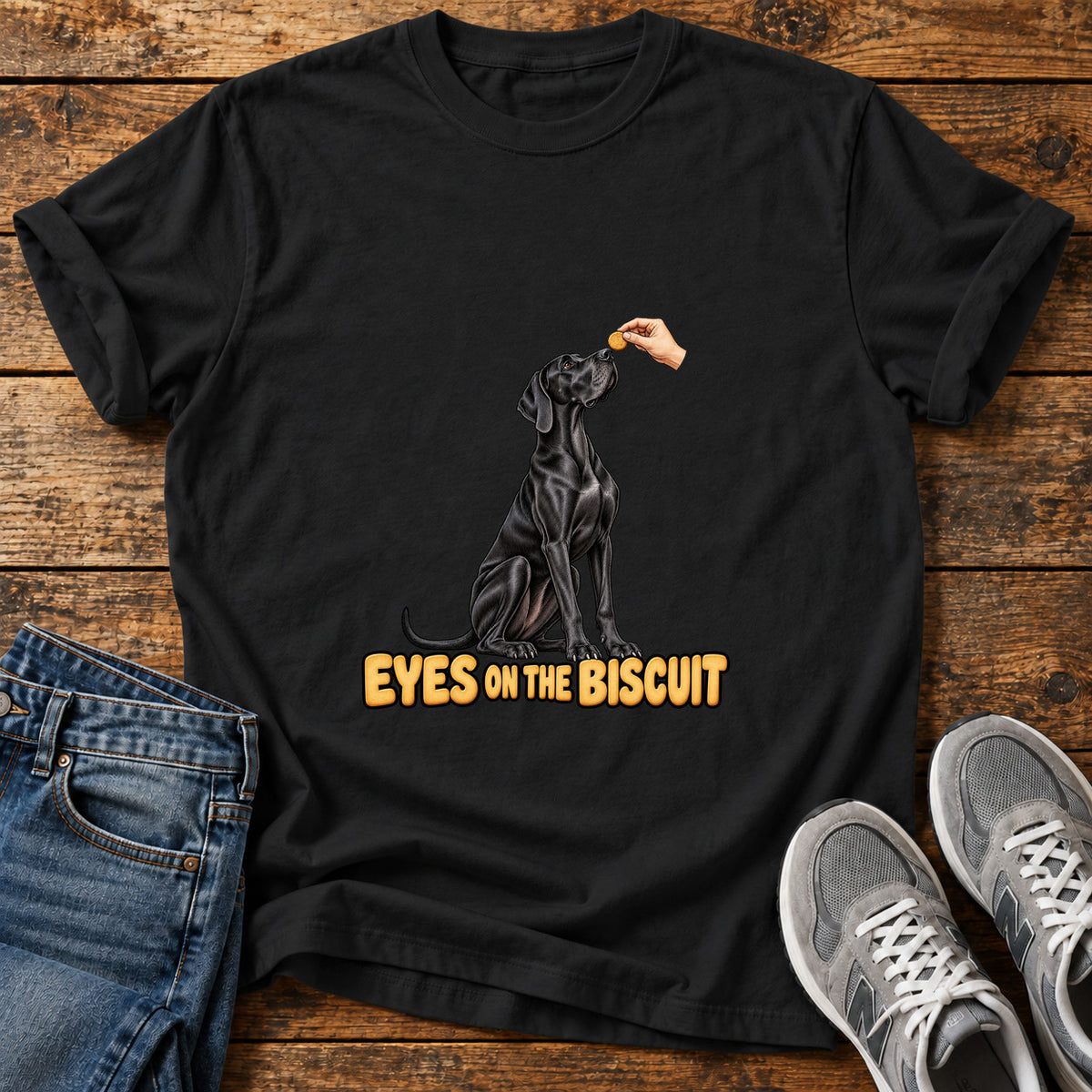 Eyes on Biscuit Great Dane graphic T-shirt in Black, shown on a flat-lay shirt mockup