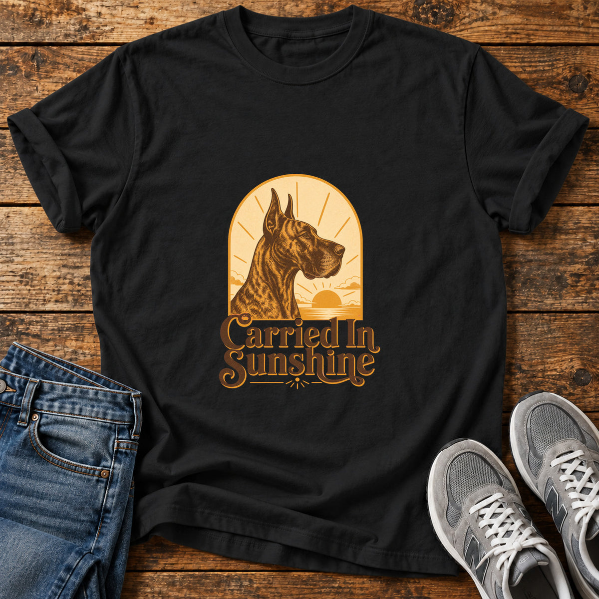 Carried In Sunshine Great Dane graphic T-shirt in Black, shown on a flat-lay shirt mockup