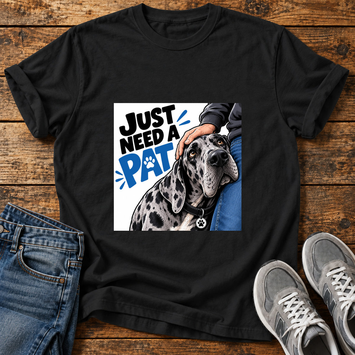 Just Need Pat Great Dane graphic T-shirt in Black, shown on a flat-lay shirt mockup