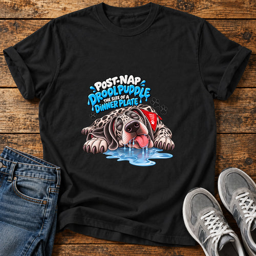 Drool Puddle Dog Great Dane graphic T-shirt in Black, shown on a flat-lay shirt mockup