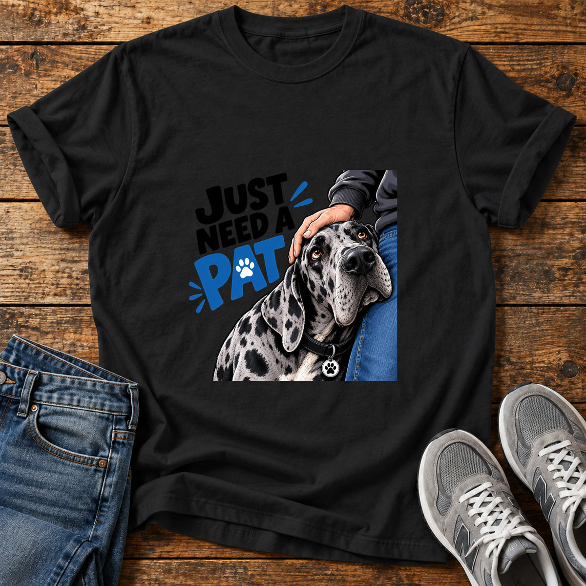 Just Need Pat Great Dane graphic T-shirt in Black, shown on a flat-lay shirt mockup