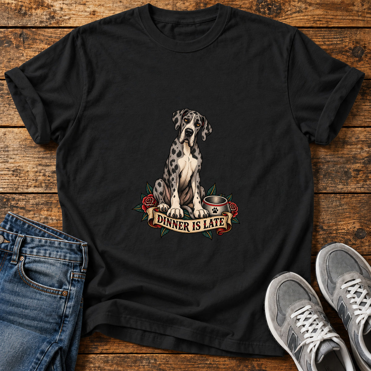 Dinner Is Late Great Dane graphic T-shirt in Black, shown on a flat-lay shirt mockup