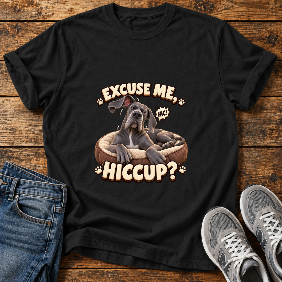 Excuse Hiccup Great Dane graphic T-shirt in Black, shown on a flat-lay shirt mockup