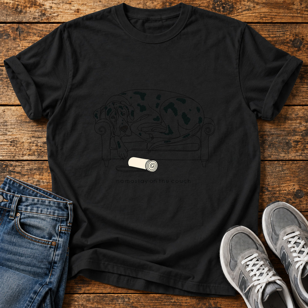 Namastay Couch Great Dane graphic T-shirt in Black, shown on a flat-lay shirt mockup
