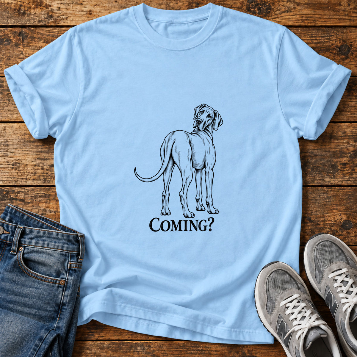 Coming Dog Great Dane graphic T-shirt in Light Blue, shown on a flat-lay shirt mockup