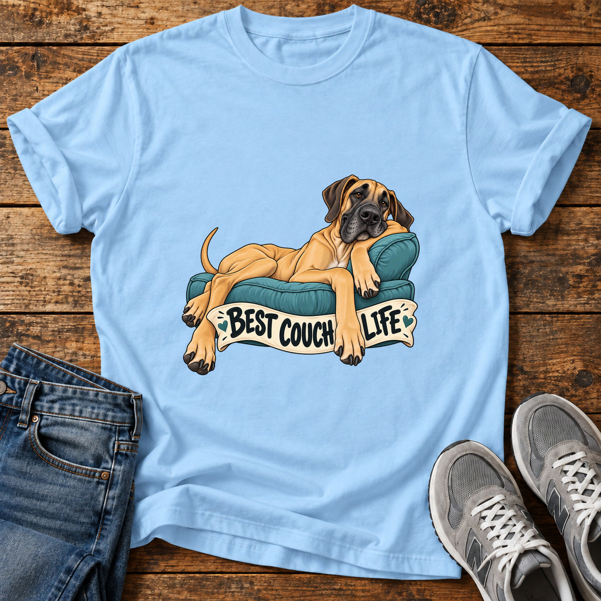 Best Couch Life Great Dane graphic T-shirt in Light Blue, shown on a flat-lay shirt mockup