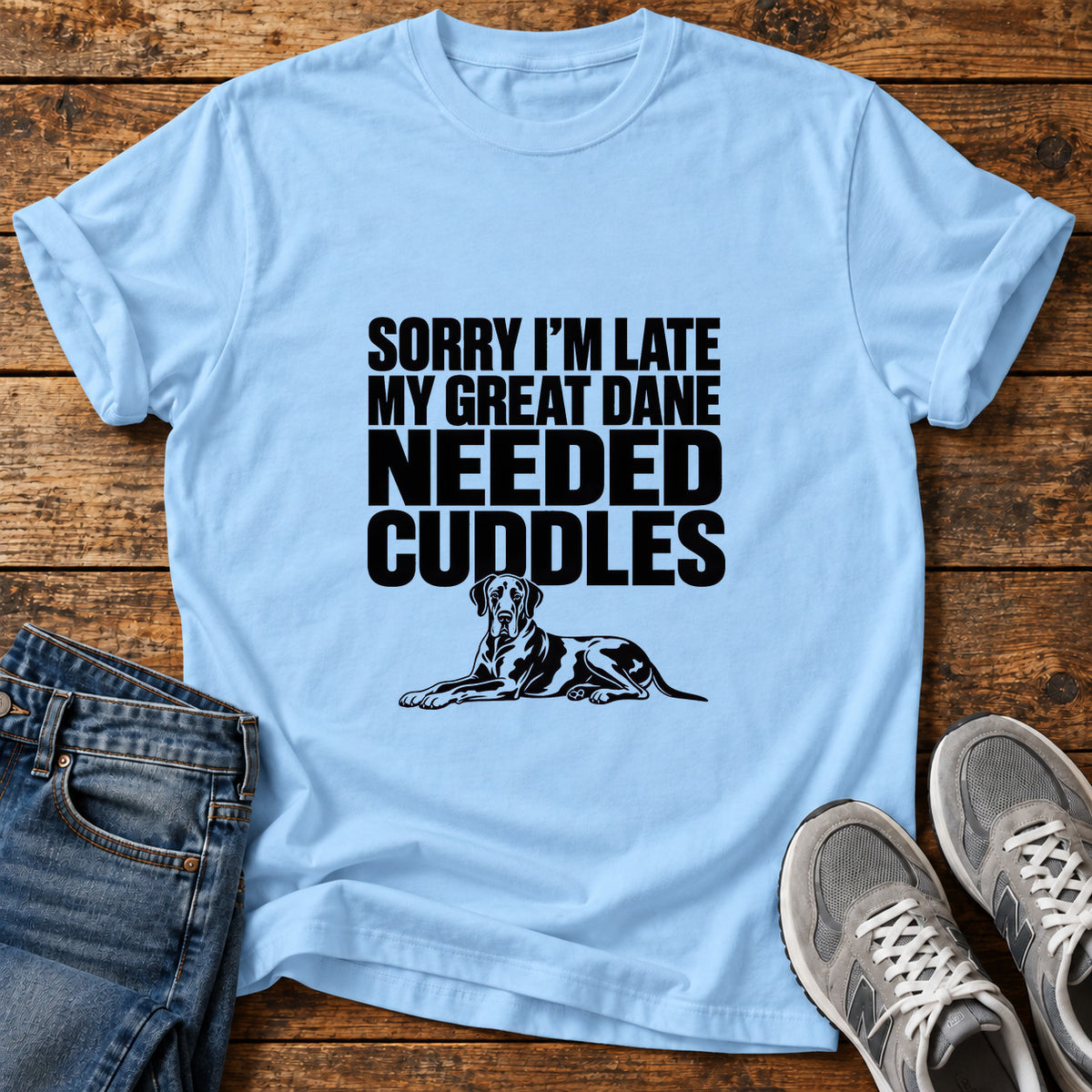 Great Dane Cuddles graphic T-shirt in Light Blue, shown on a flat-lay shirt mockup