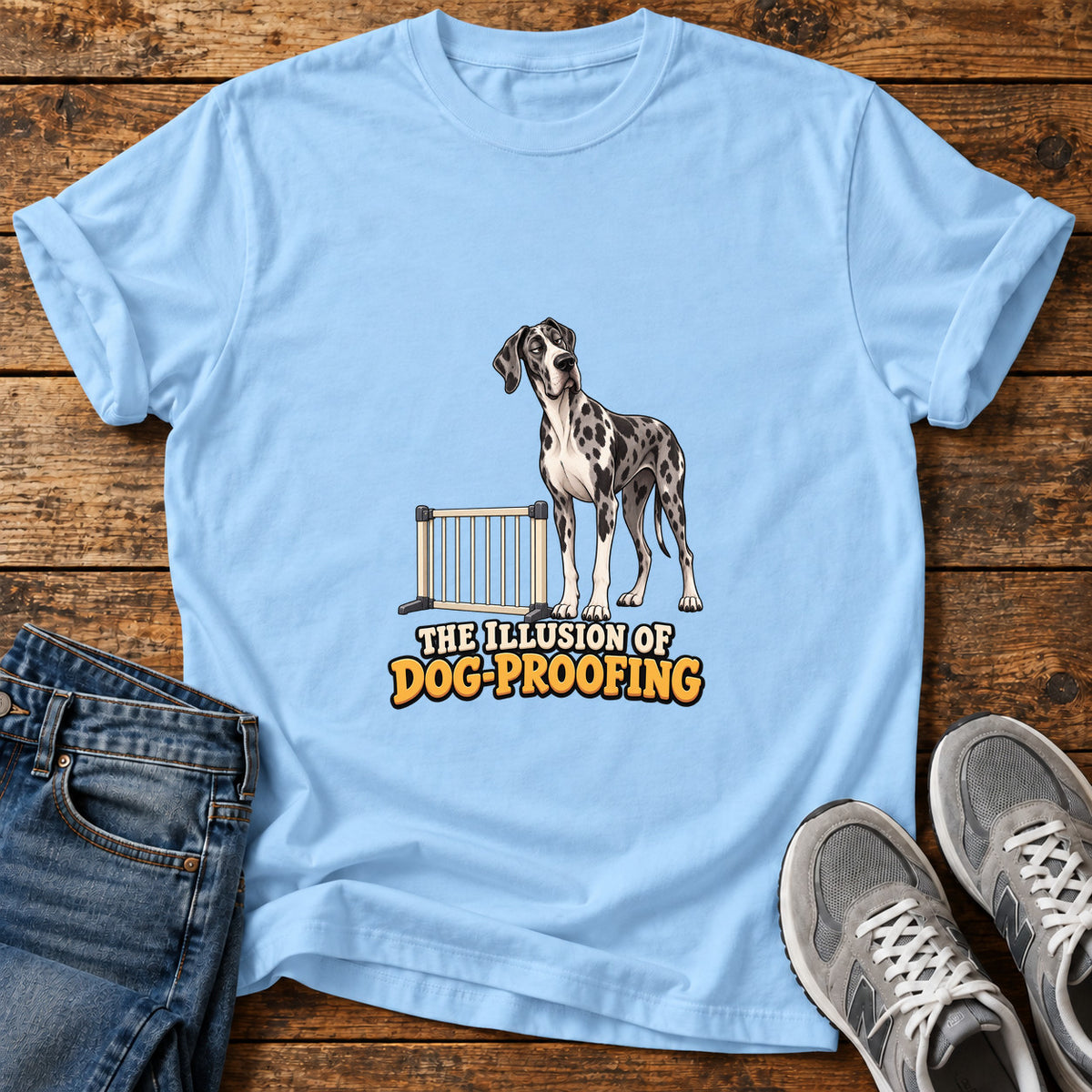 Dog Proofing Illusion Great Dane graphic T-shirt in Light Blue, shown on a flat-lay shirt mockup