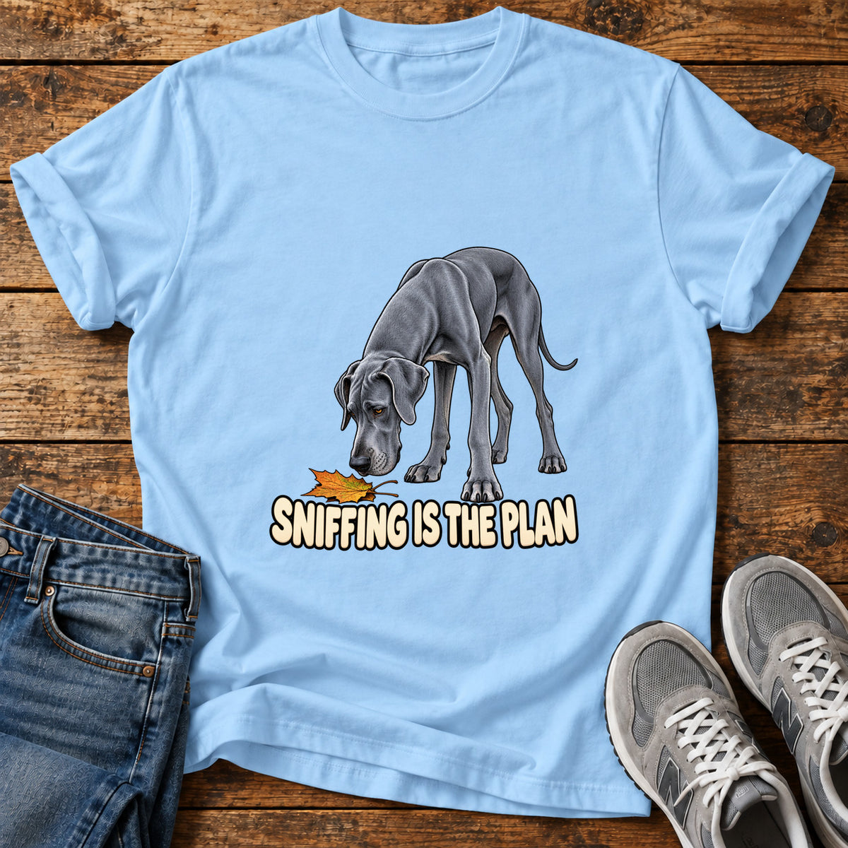 Sniffing Plan Great Dane graphic T-shirt in Light Blue, shown on a flat-lay shirt mockup