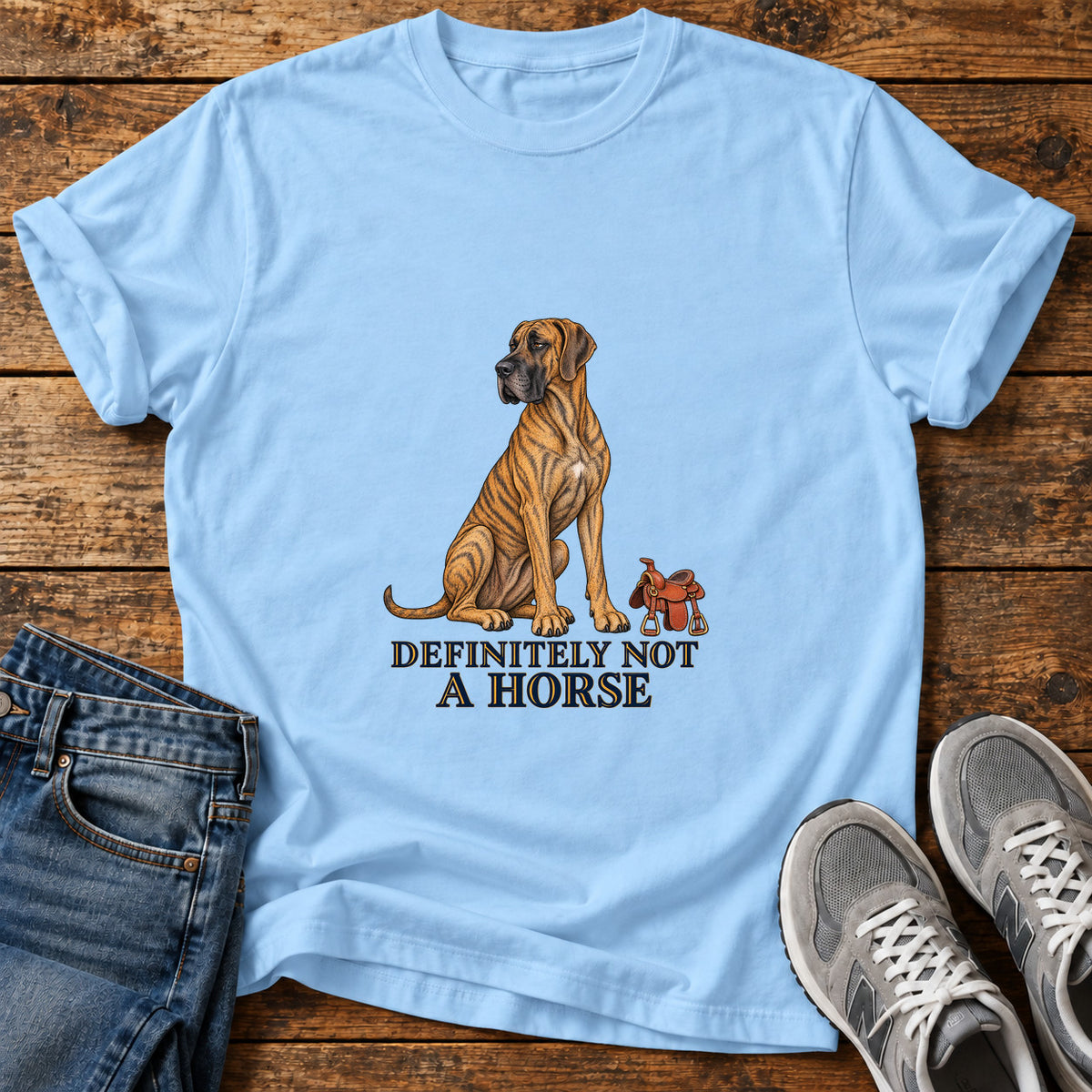 Definitely Not Horse Great Dane graphic T-shirt in Light Blue, shown on a flat-lay shirt mockup