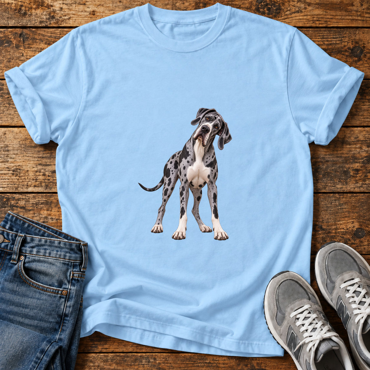 Spotted Curious Great Dane graphic T-shirt in Light Blue, shown on a flat-lay shirt mockup