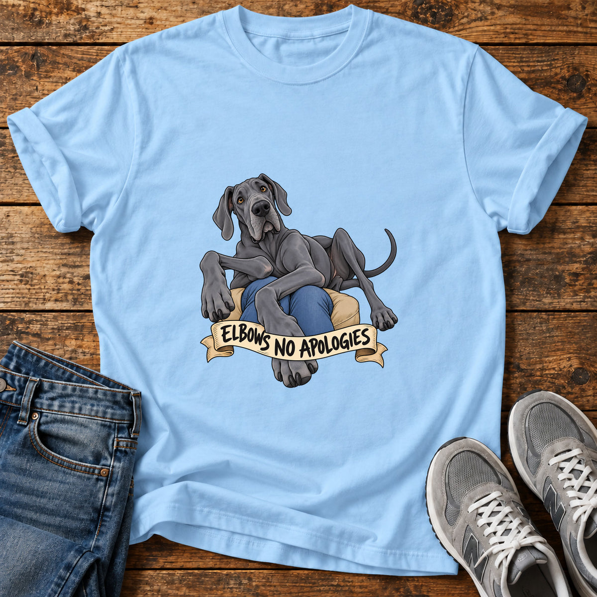 Elbows No Apologies Great Dane graphic T-shirt in Light Blue, shown on a flat-lay shirt mockup
