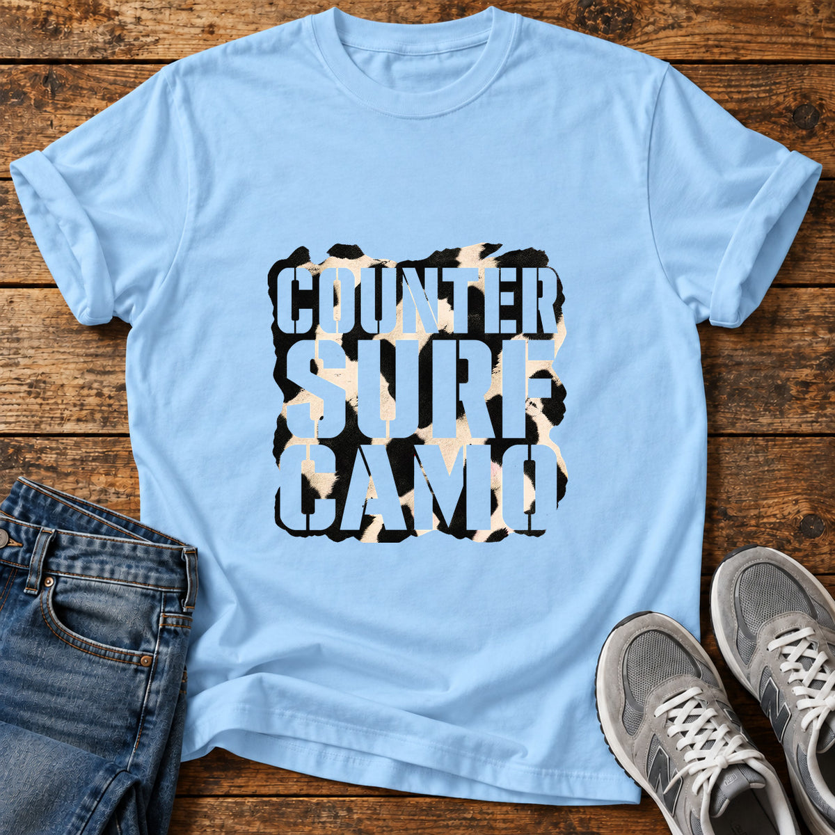 Counter Surf Camo Great Dane graphic T-shirt in Light Blue, shown on a flat-lay shirt mockup