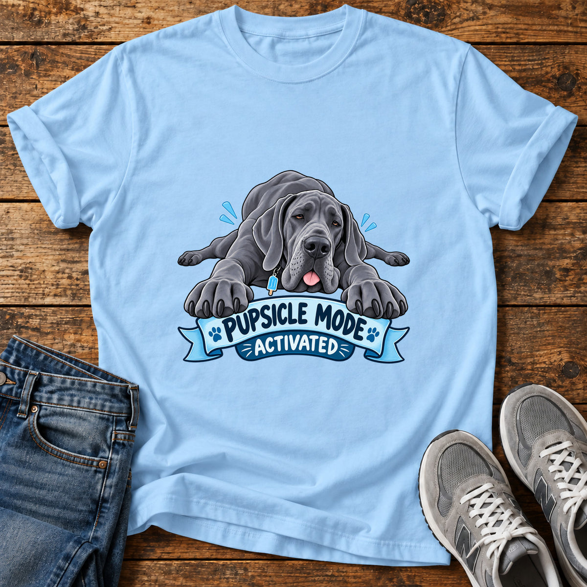 Pupsicle Mode Great Dane graphic T-shirt in Light Blue, shown on a flat-lay shirt mockup