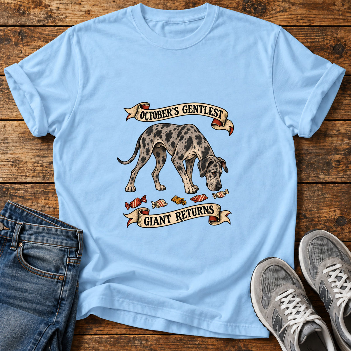 October's Gentlest Great Dane graphic T-shirt in Light Blue, shown on a flat-lay shirt mockup