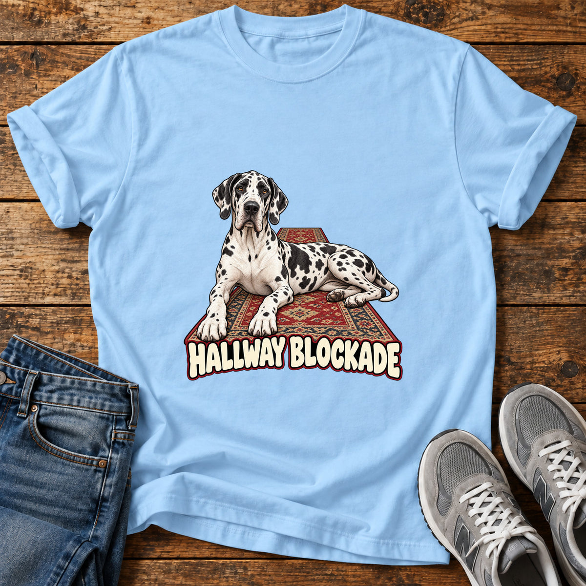 Hallway Blockade Great Dane graphic T-shirt in Light Blue, shown on a flat-lay shirt mockup