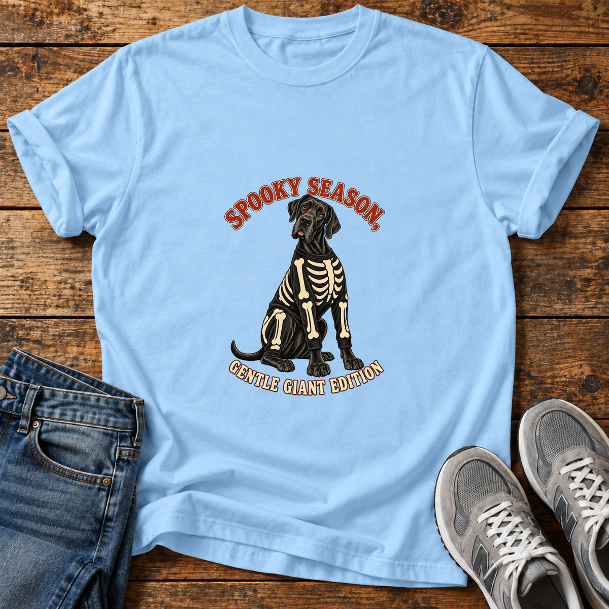 Spooky Gentle Giant Great Dane graphic T-shirt in Light Blue, shown on a flat-lay shirt mockup
