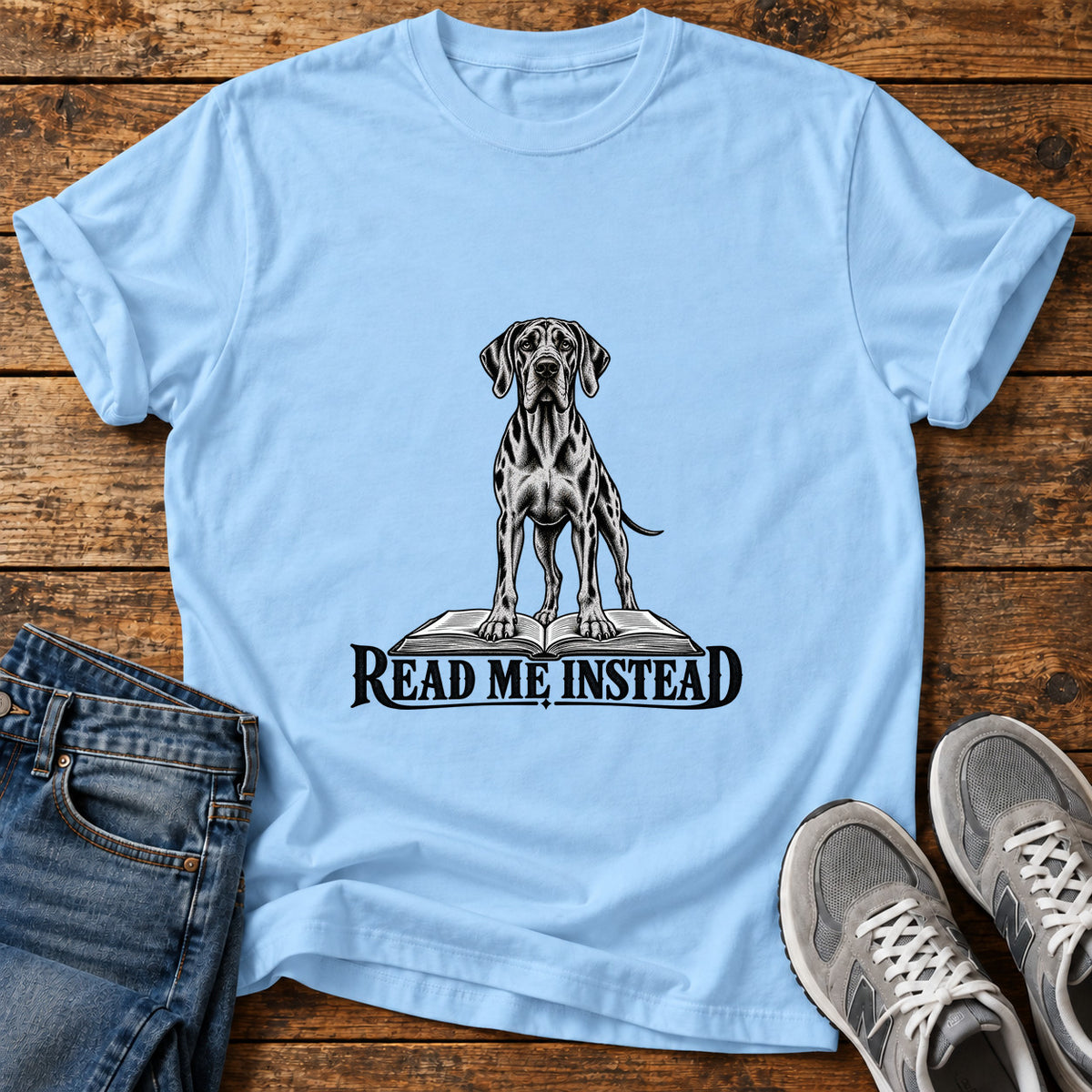 Read Me Instead Great Dane graphic T-shirt in Light Blue, shown on a flat-lay shirt mockup
