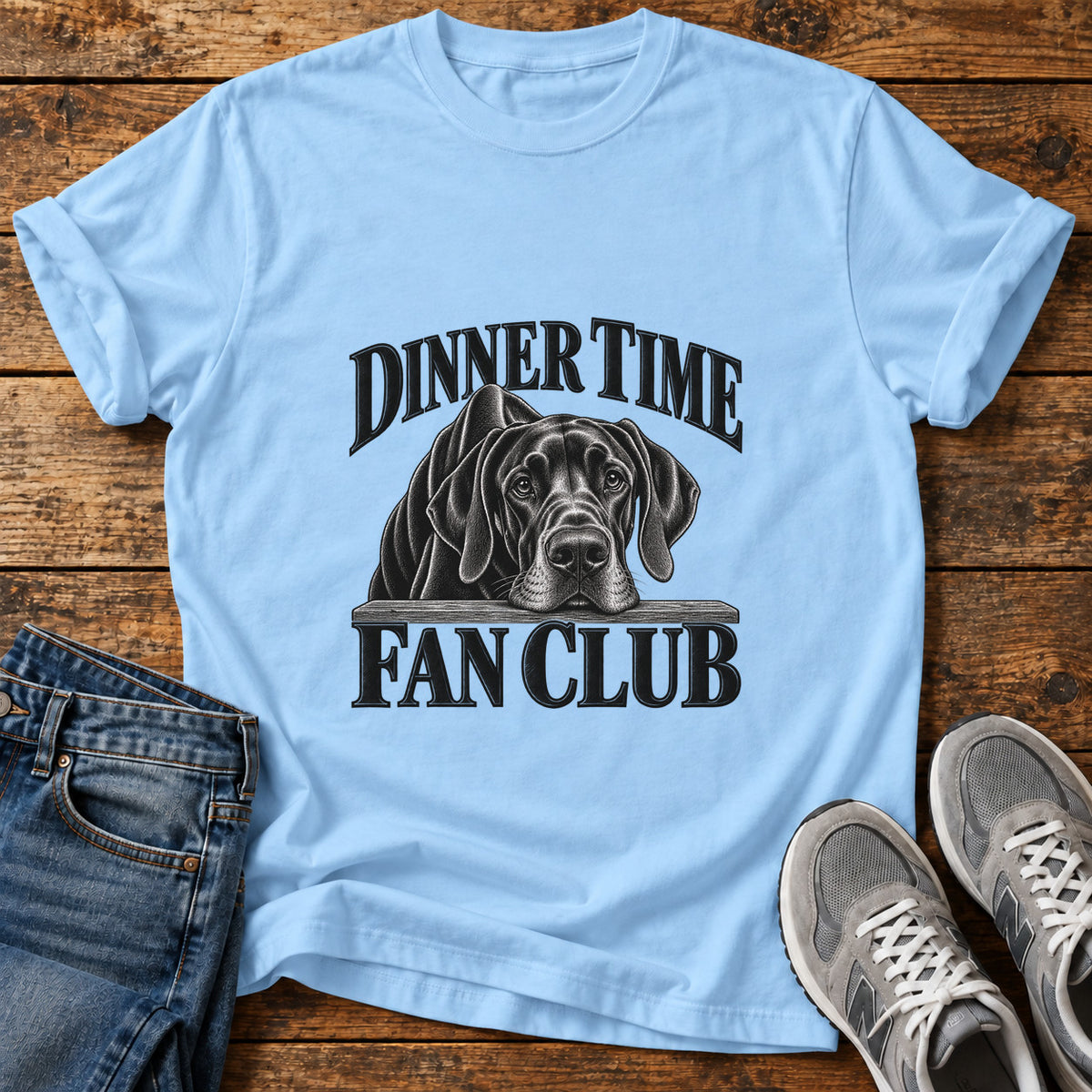 Dinner Time Club Great Dane graphic T-shirt in Light Blue, shown on a flat-lay shirt mockup