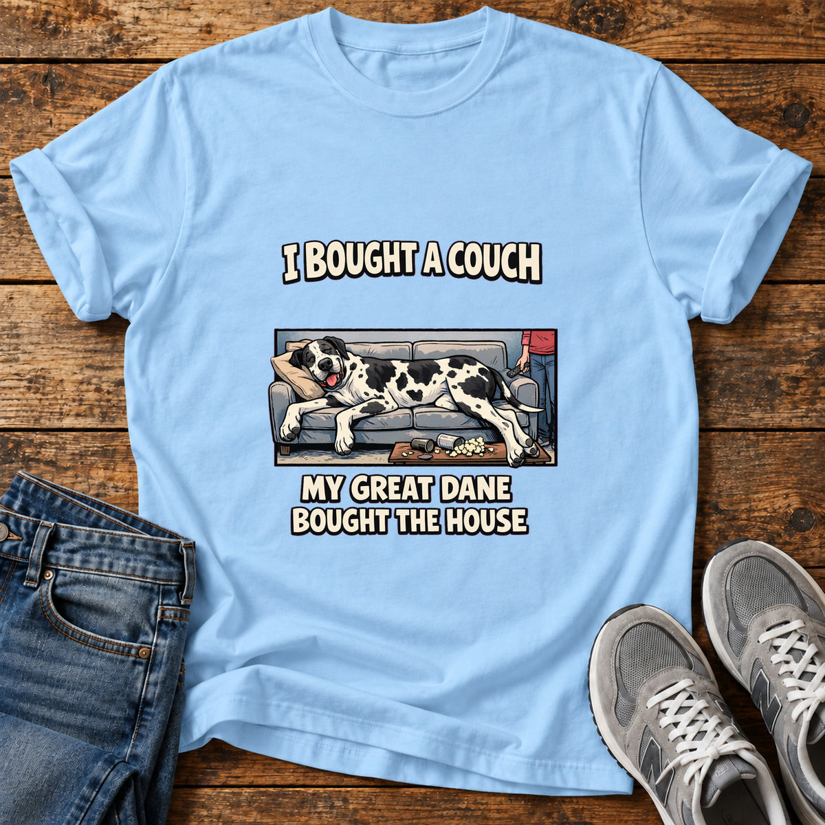 Great Dane Couch graphic T-shirt in Light Blue, shown on a flat-lay shirt mockup