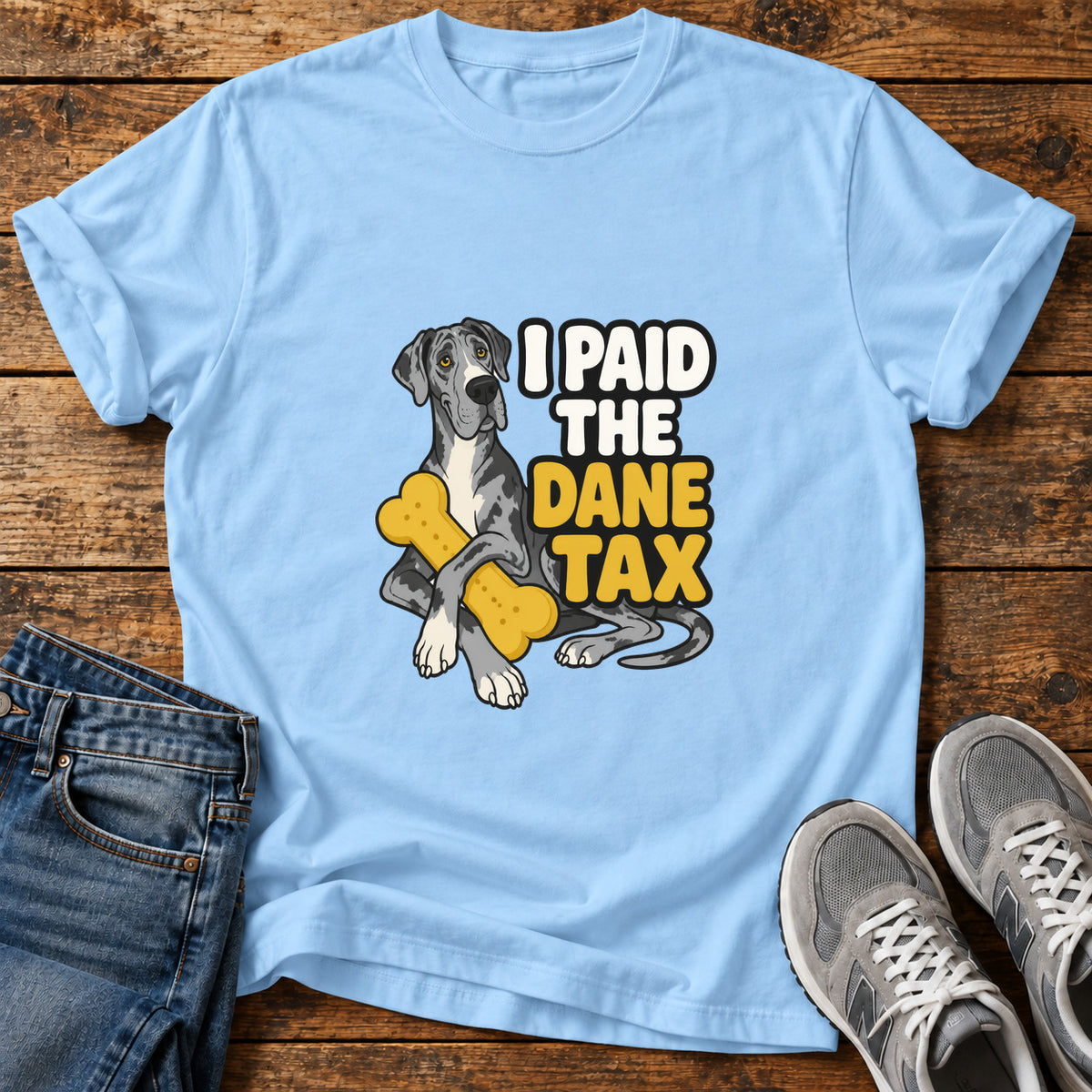 Dane Taxpayer Great Dane graphic T-shirt in Light Blue, shown on a flat-lay shirt mockup
