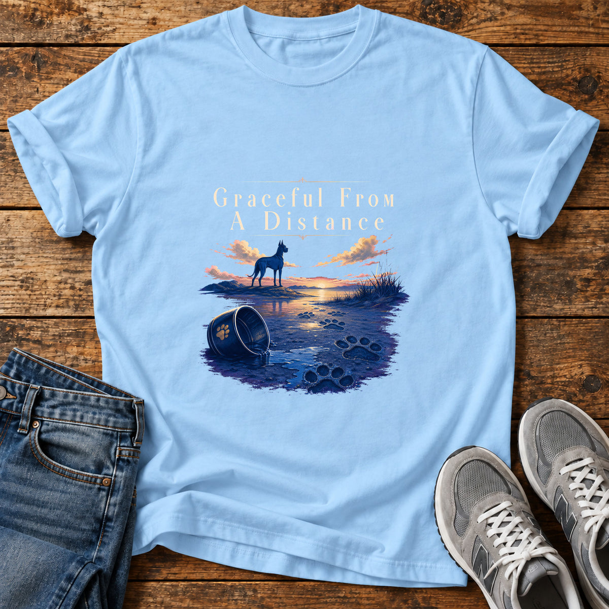 Graceful Distance Great Dane graphic T-shirt in Light Blue, shown on a flat-lay shirt mockup