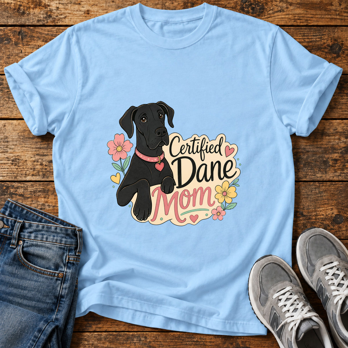 Certified Dane Mom Great Dane graphic T-shirt in Light Blue, shown on a flat-lay shirt mockup