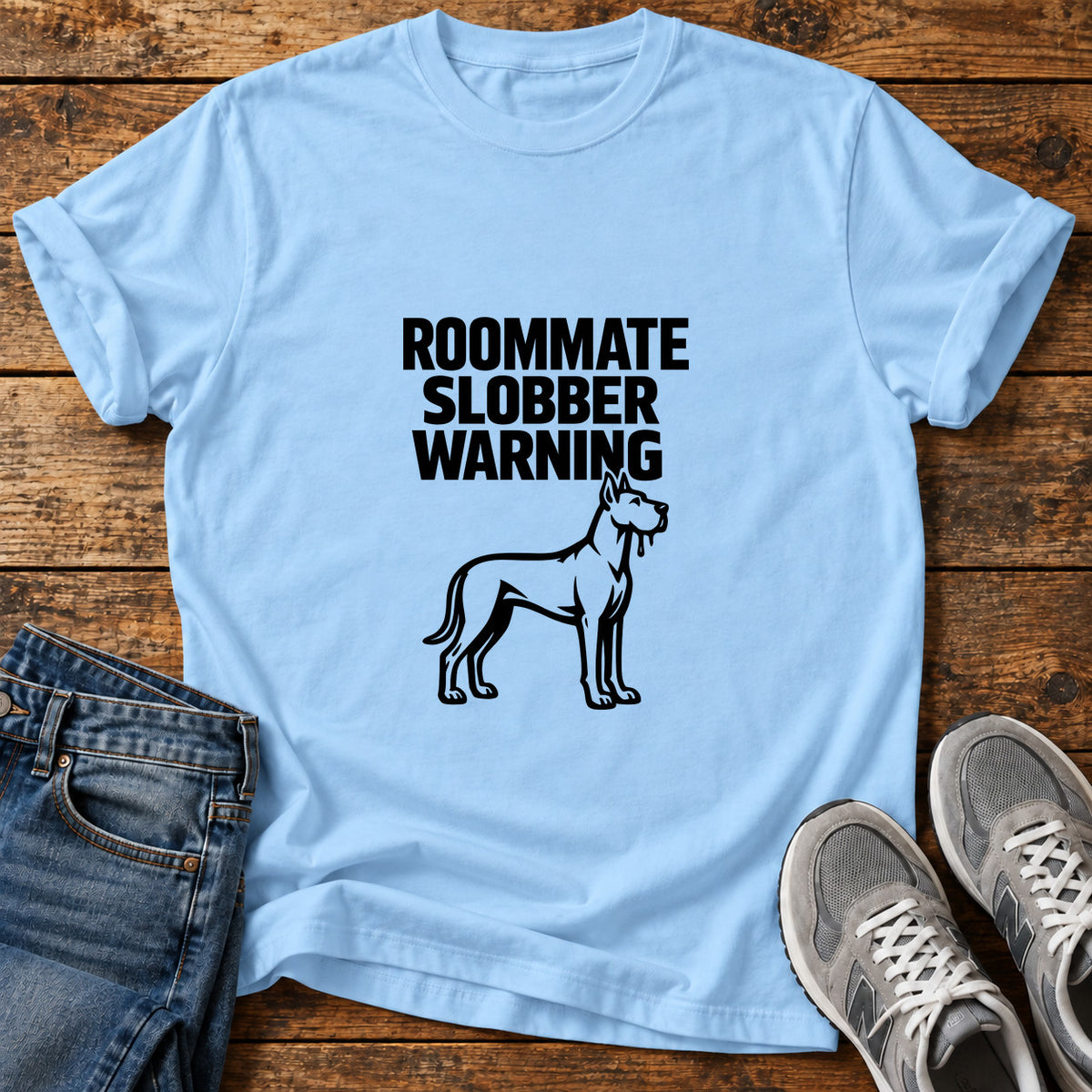 Roommate Slobber Warning Great Dane graphic T-shirt in Light Blue, shown on a flat-lay shirt mockup