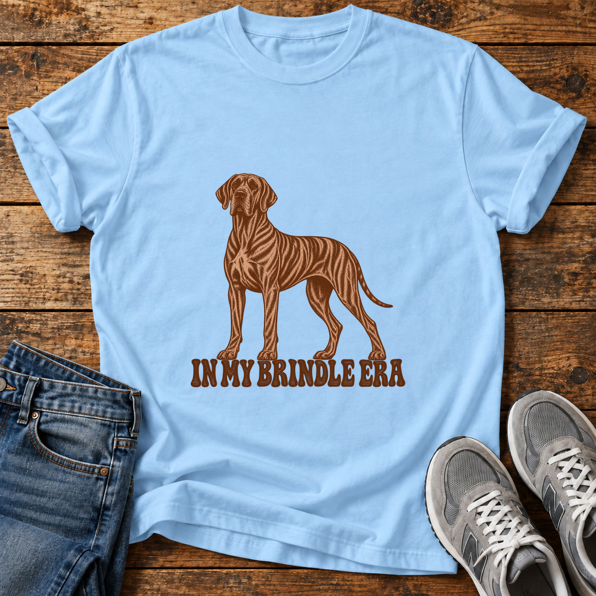 Brindle Era Great Dane graphic T-shirt in Light Blue, shown on a flat-lay shirt mockup