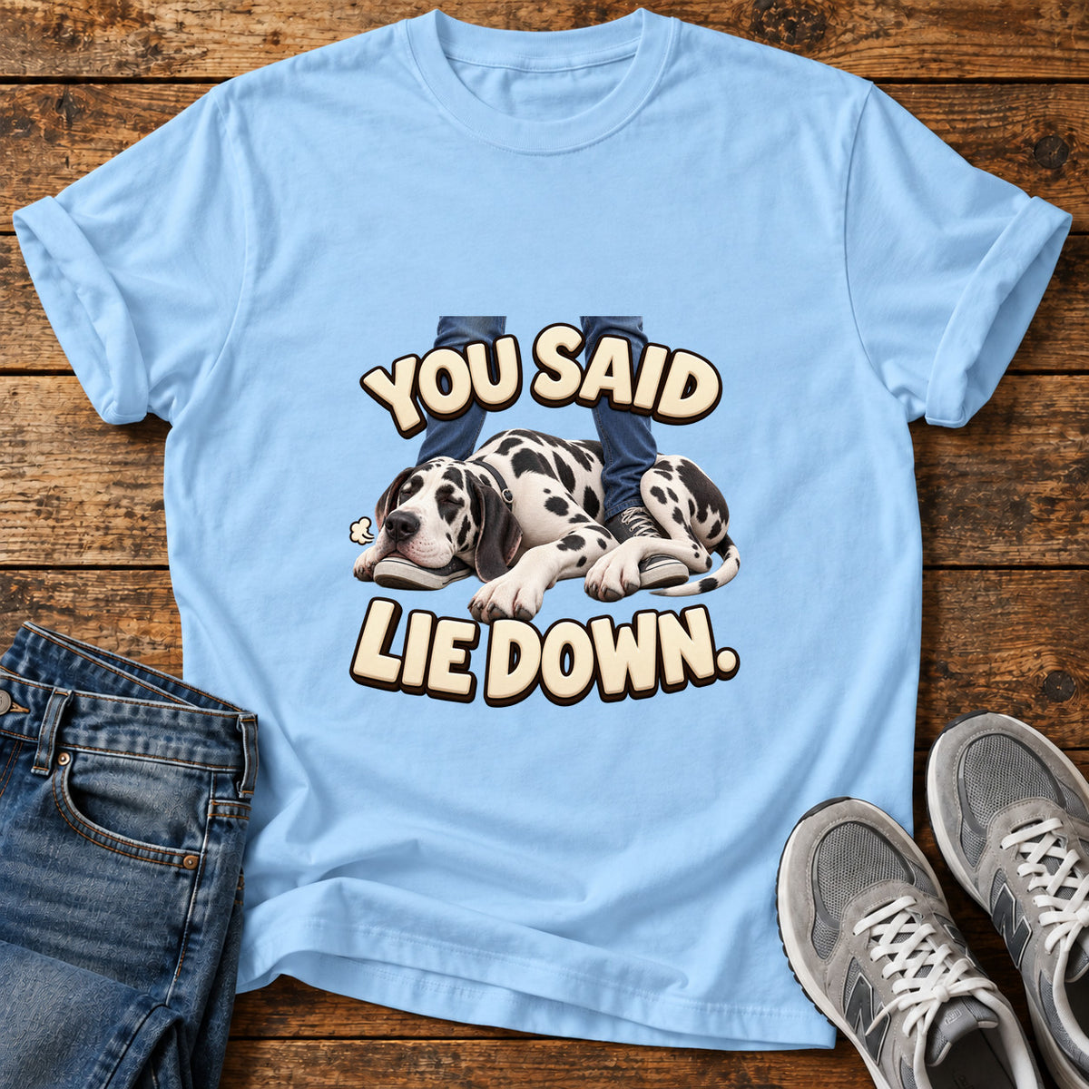 Lie Down Paws Great Dane graphic T-shirt in Light Blue, shown on a flat-lay shirt mockup