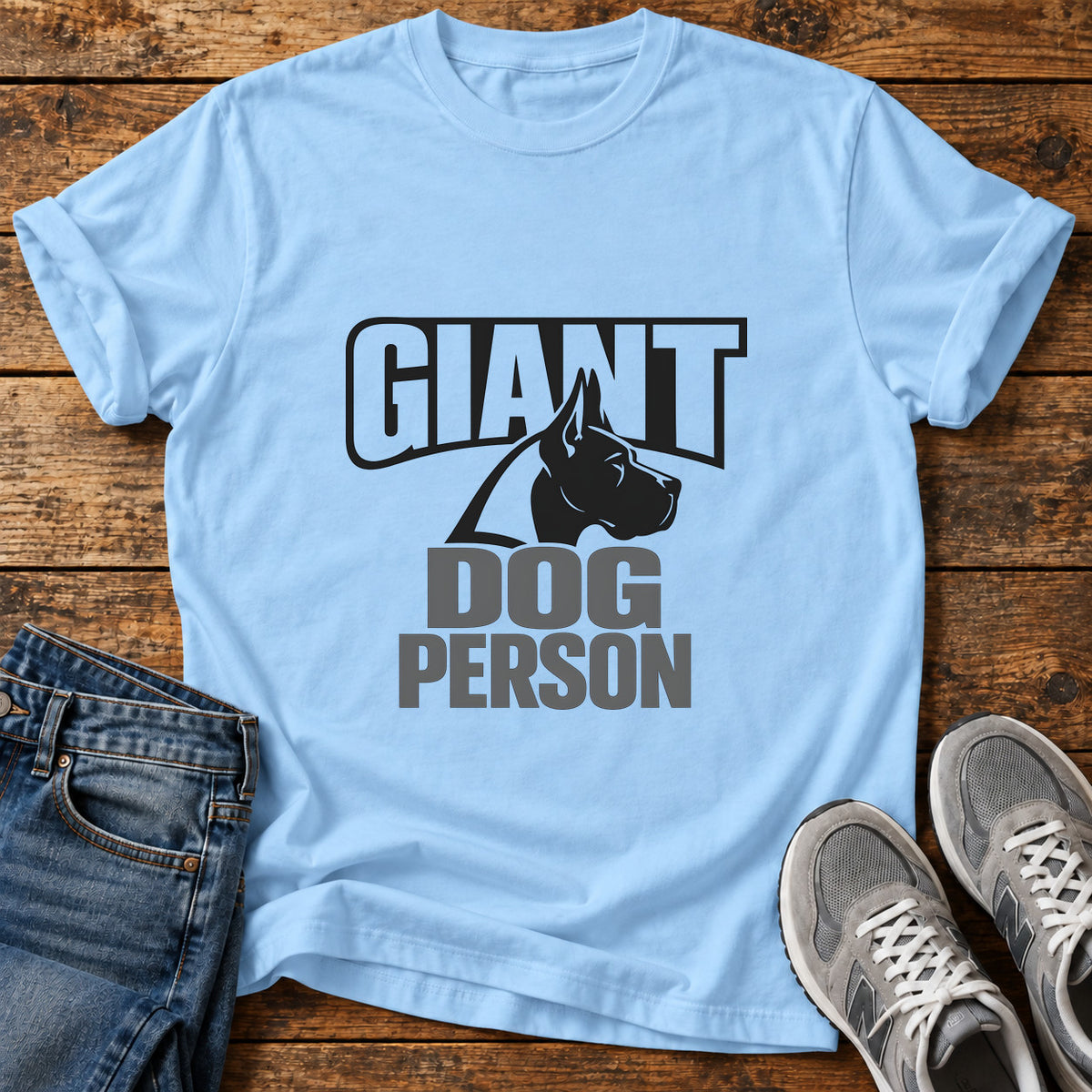 Giant Dog Person Great Dane graphic T-shirt in Light Blue, shown on a flat-lay shirt mockup