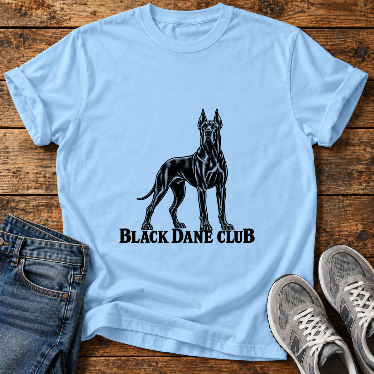 Black Dane Club Great Dane graphic T-shirt in Light Blue, shown on a flat-lay shirt mockup