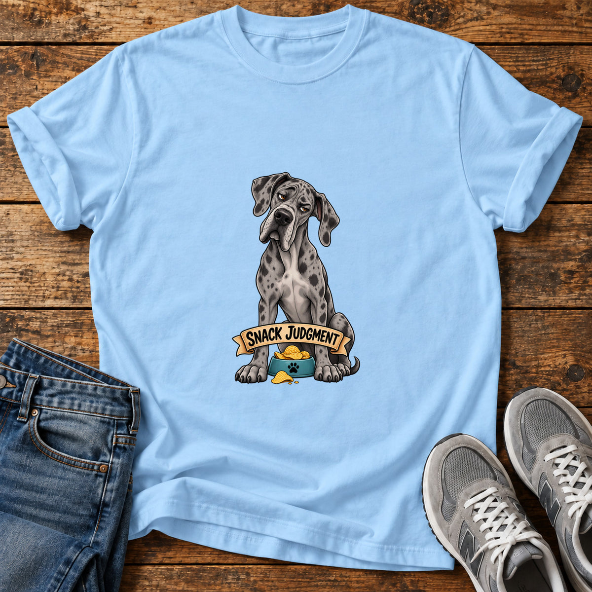Snack Judgment Great Dane graphic T-shirt in Light Blue, shown on a flat-lay shirt mockup