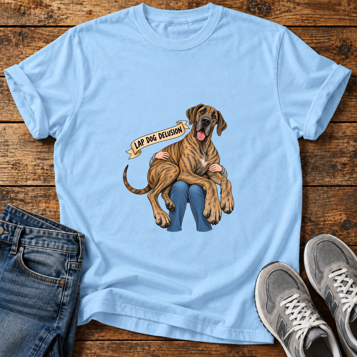 Lap Dog Delusion Great Dane graphic T-shirt in Light Blue, shown on a flat-lay shirt mockup