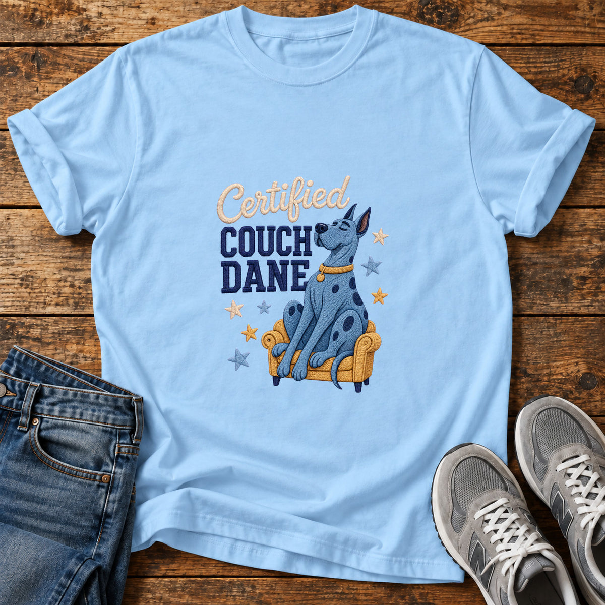 Certified Couch Dane Great Dane graphic T-shirt in Light Blue, shown on a flat-lay shirt mockup