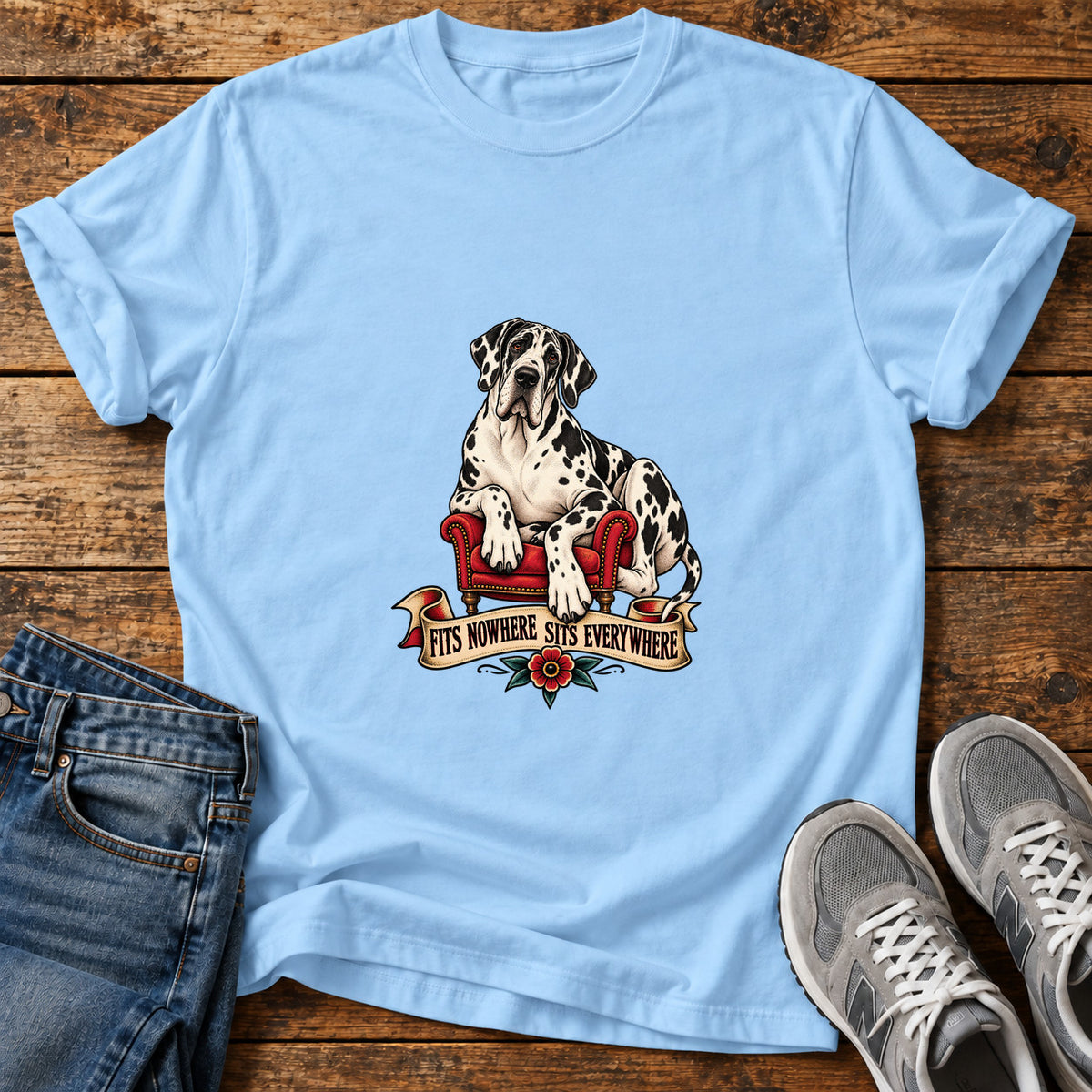 Sits Everywhere Great Dane graphic T-shirt in Light Blue, shown on a flat-lay shirt mockup