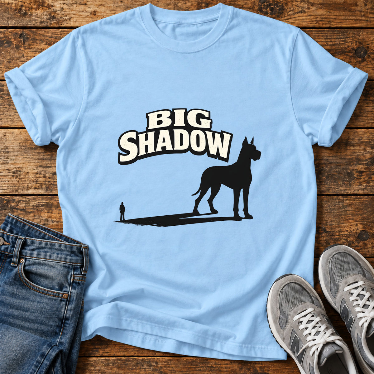 Big Shadow Great Dane graphic T-shirt in Light Blue, shown on a flat-lay shirt mockup