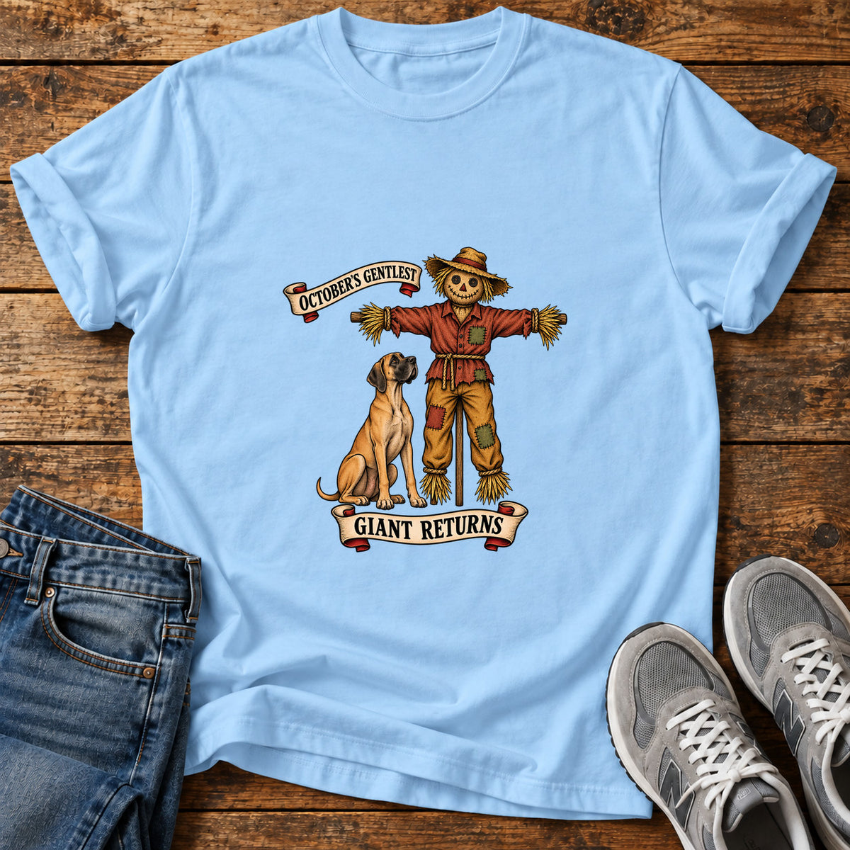 October's Gentlest Great Dane graphic T-shirt in Light Blue, shown on a flat-lay shirt mockup