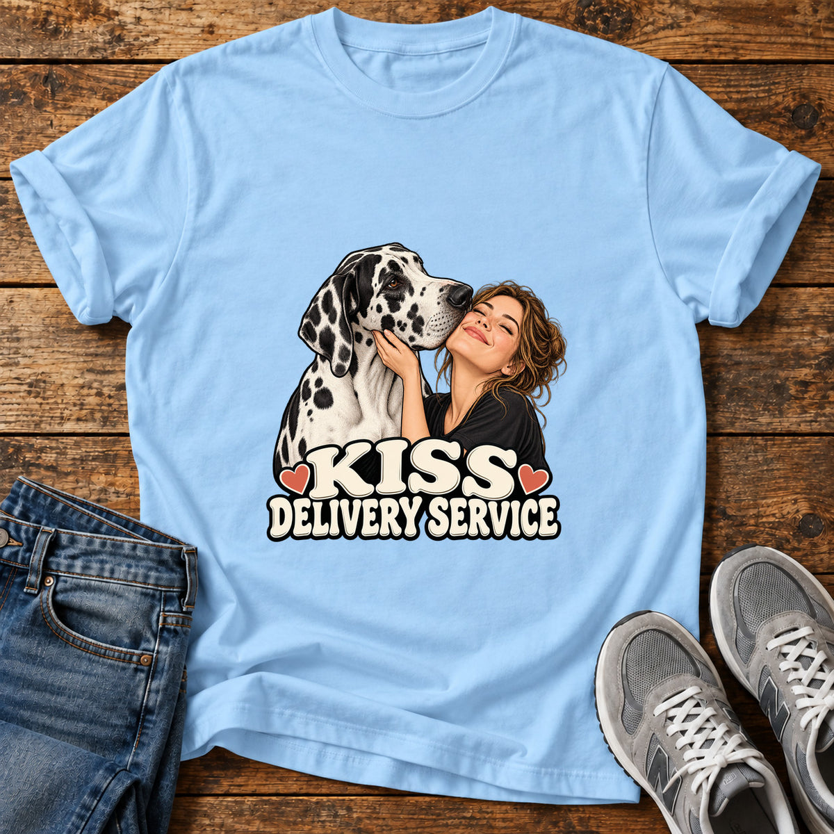 Kiss Delivery Great Dane graphic T-shirt in Light Blue, shown on a flat-lay shirt mockup