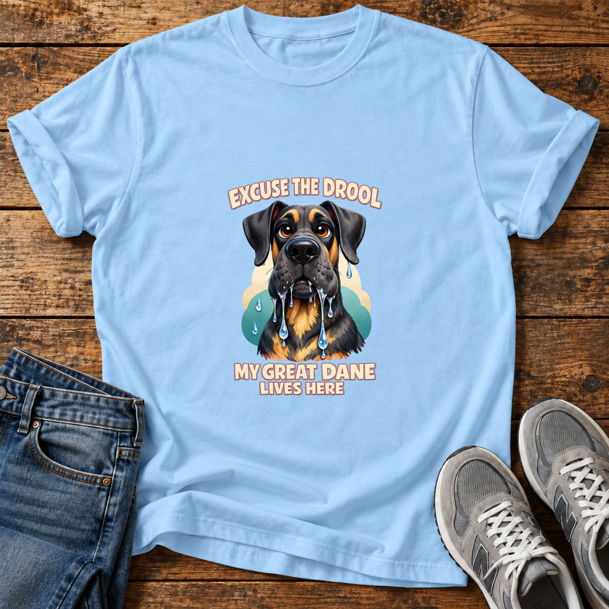 Excuse The Drool Great Dane graphic T-shirt in Light Blue, shown on a flat-lay shirt mockup
