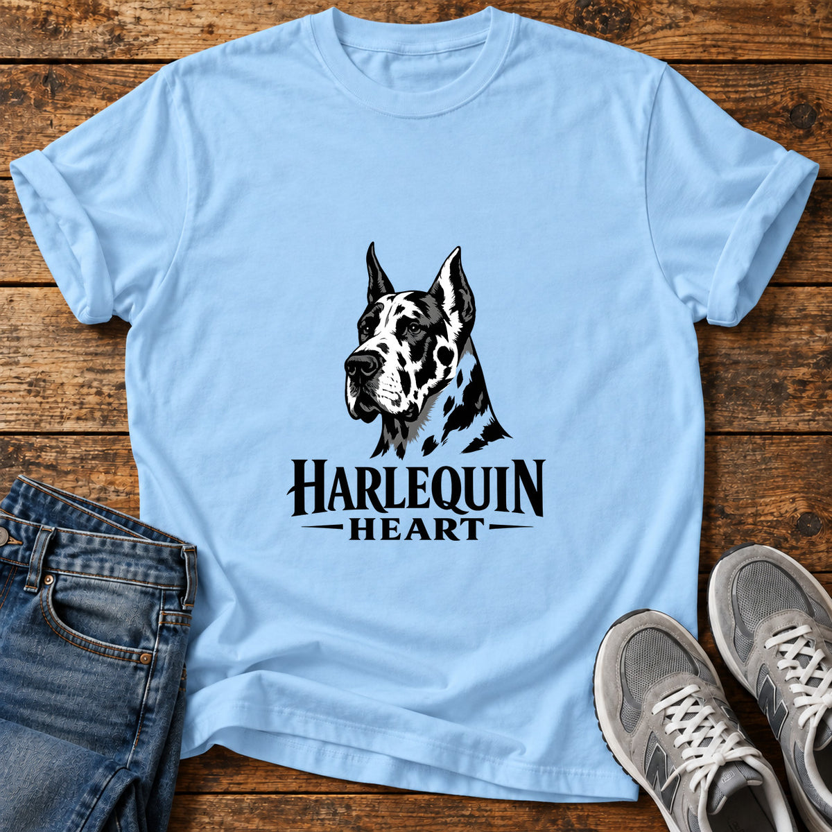 Harlequin Heart Great Dane graphic T-shirt in Light Blue, shown on a flat-lay shirt mockup