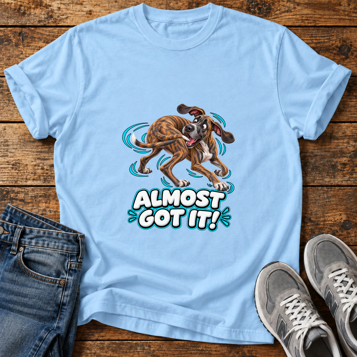 Almost Got It Great Dane graphic T-shirt in Light Blue, shown on a flat-lay shirt mockup