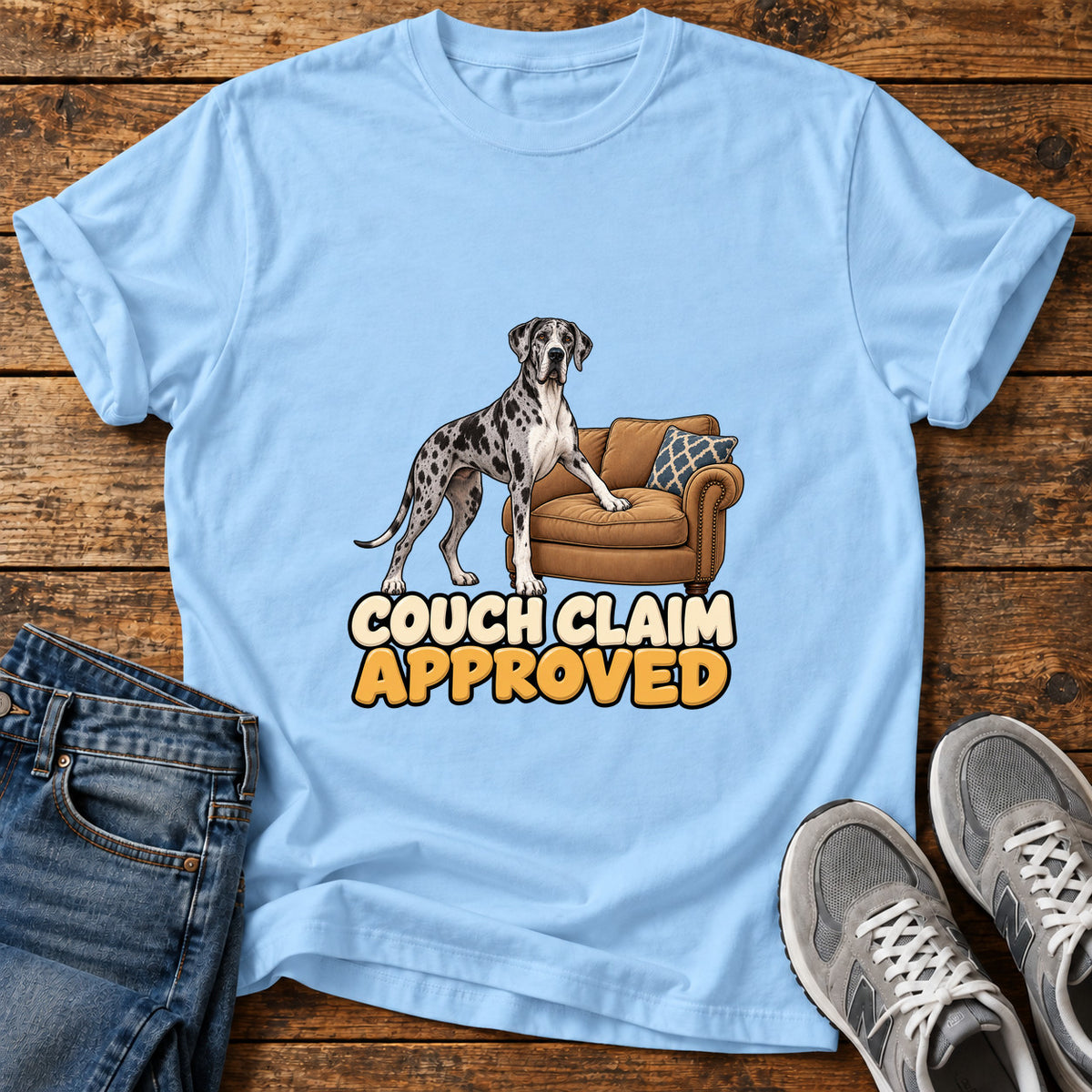 Couch Claim Approved Great Dane graphic T-shirt in Light Blue, shown on a flat-lay shirt mockup
